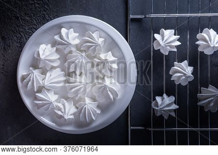 Still Life With Few White Meringue Cookies On White Porcelain Round Plate And On Metal Grate. Textur