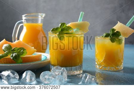Refreshing Drinks And Citrus Juices  With Ice Cubes, Mint And Melon. Summer Concept