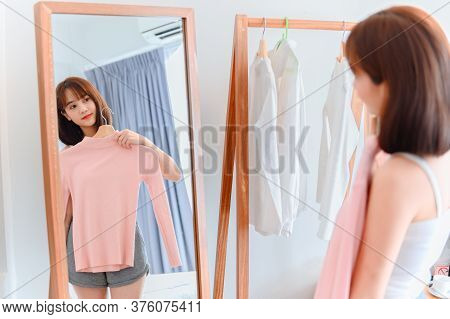 Asian Woman Dress-up At Home. Daily Lifestyle In The Bedroom. Social Distancing And Self-quarantine.