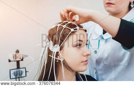 Doctor And Patient With Encephalography Electrode. Electroencephalogram