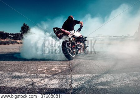 Moscow, Russia - 12 Jul 2020: Moto Rider Making A Stunt On His Motorbike. Stunt Motorcycle Rider Per