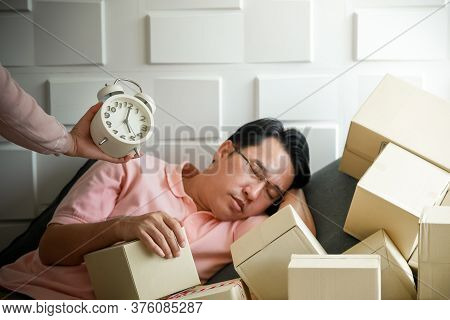 Asian Men Are Falling Asleep Because To Tired Of Handling The Order-based Goods From Online Customer