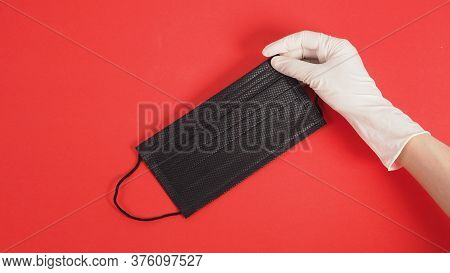Hand With Gloves And Black Disposable Ear- Loop Face Mask For Protection From Virus Infection And Ch