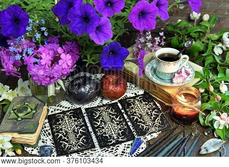 Tarot Cards Layout With Poisonous Apples And Petunia Flowers On Witch Altar Table. Esoteric, Wicca A