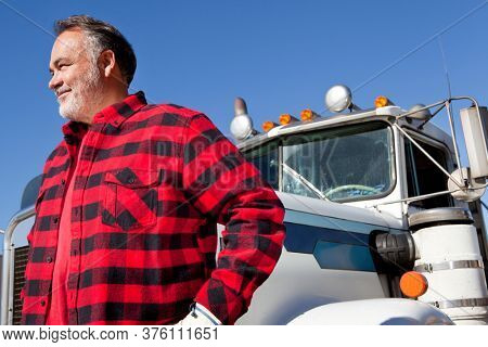 Trucker standing in front of Cargo truck