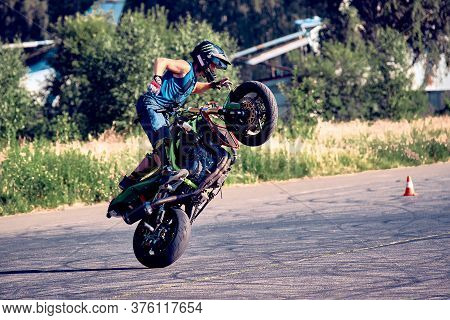 Moscow, Russia - 12 Jul 2020: Moto Rider Making A Stunt On His Motorbike. Stunt Motorcycle Rider Per