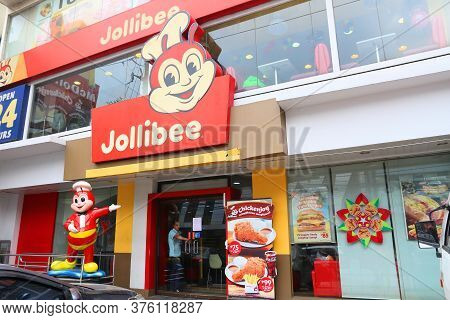Manila, Philippines - December 7, 2017: People Visit Jollibee Fast Food Restaurant In Manila, Philip