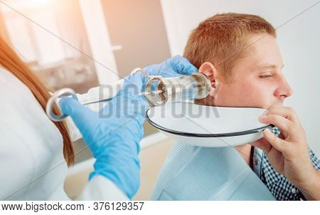 Medical Ear Washing With Water In Big Syringe