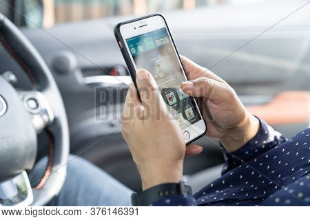 Bangkok, Thailand, July 1, 2020 Holding Iphone In Toyota Sienta Car To Communication With Family And