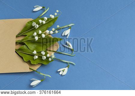 Spring Flowers In A Mail Envelope On A Blue Background. Romantic Birthday Greetings, Creative Weddin