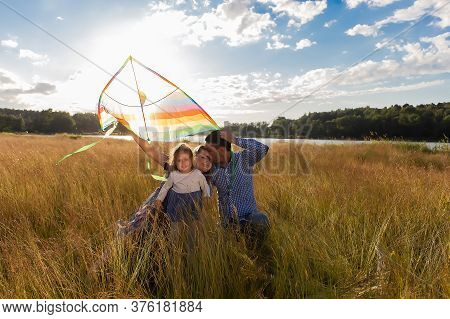 The Family Launches Kite Against Beautiful Sky