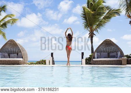 Young Women With Arms Apart On Sand Beach.