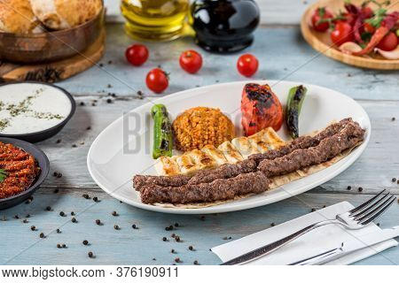 Shish Meatball Kebab From Turkish Cuisine. Served With White Plate On Wooden Table.