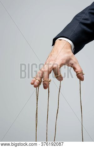 Cropped View Of Puppeteer With Strings On Fingers Isolated On Grey