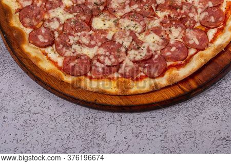 Pepperoni Pizza In Brazil Is Called Pizza De Calabresa  On Gray Background.