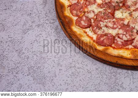 Pepperoni Pizza In Brazil Is Called Pizza De Calabresa  On Gray Background.