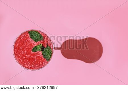Strawberry Smoothie Or Alcohol Cocktail In Wineglass Decorated With Mint On Pink Background. Healthy