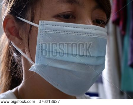 Cloeup Face Of Illness Woman Protect With Hygienic Mask Against From Contagious Disease,hopeless Eye
