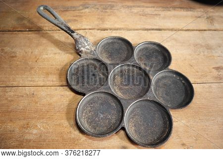 Old Vintage Antique Mini Pancake Pan On A Wooden Board