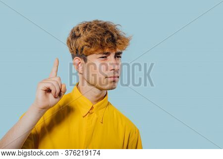 Seriously Boy Pointing Fingers Up, At Copy Space, Isolated Over Blue Background, Teenager Cu Coafura