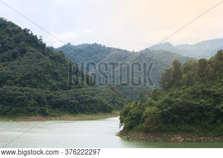The Reservoir Is Between The Valleys. In The Green Nature On A Clear Day The Sky And Air
