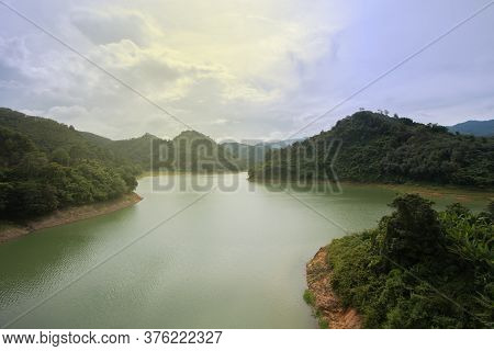 The Reservoir Is Between The Valleys. In The Green Nature On A Clear Day The Sky And Air