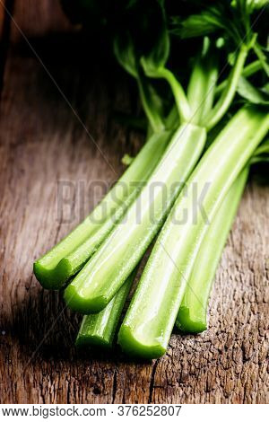 Stems Of Fresh Celery With Leaves On The Table, Vintage Wooden Background, Selective Focus