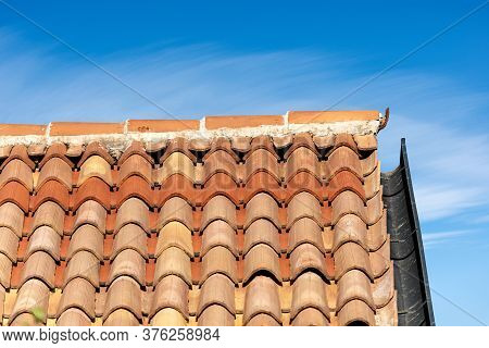 Pantiles. Closeup Of A Roof With Terracotta Tiles (coppo In Italian Language) And Gutter On A Blue S