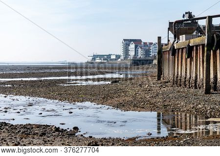 Coastline In Zeeuwse Village Yerseke With Famous Oysters Wells During Low Tide, Zeeland, Netherlands
