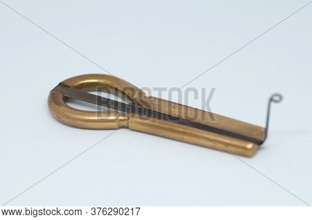 Macrophotography Of An Old Jaw Harp - Isolated On White Background