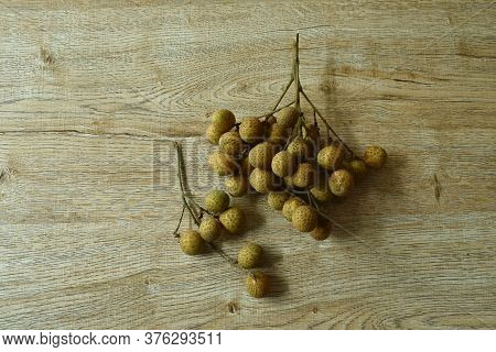 Longan Tropical Fruit In Branch On Wooden Table