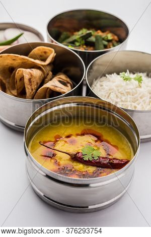 Indian Lunch Box Or Tiffin - Spicy Ladies Finger, Dal Fry, Rice And Chapati