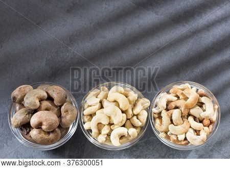 Natural And Roasted Cashew Nut On Wooden Background - Anacardium Occidentale