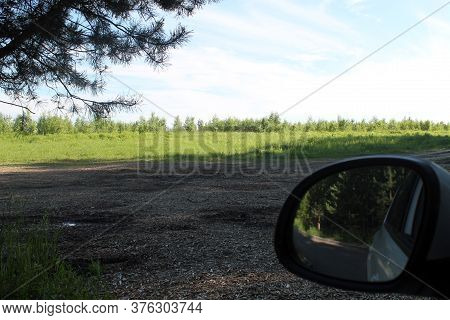 Pine Branches, Car Mirror, Green Spaces In The Distance, Blue Sky And Horizon Line. The Concept Of R