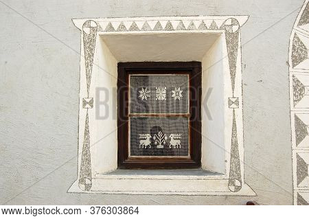 Old Wooden Window With Curtain And Decorations On The Wall In The Ancient Village Of Ardez, Scuol Mu