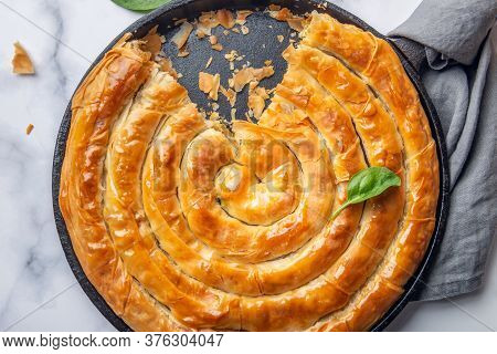 Filo Spinach And Feta Twist Pie In The Iron Pan After Oven. Authentic Greek Bakery. With Spinach, Mi