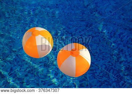 Two Rubber Air Yellow White Inflatable Balls And Toy For Swimming Pool In Transparent Blue Water. Mu
