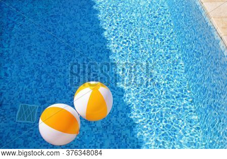 Two Rubber Air Yellow White Inflatable Balls And Toy For Swimming Pool In Transparent Blue Water. Mu