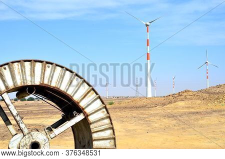 Windmills In The Backdrop Of A Winding Wheel On The Way To Sam Sand Dunes (thar Desert) From Jaisalm