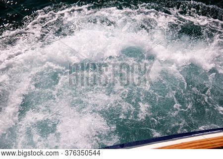 Turbulence Made By Foam Of Sea Water From A High-speed Yacht On Surface Of Sea. Blue Sea Waves With 