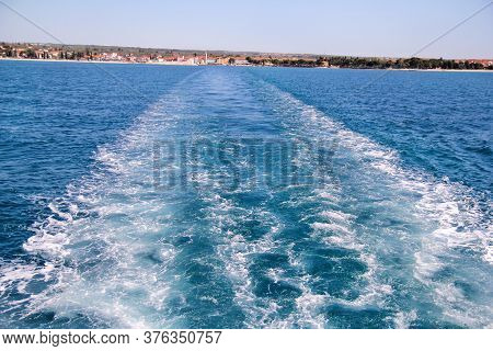 Turbulence Made By Foam Of Sea Water From A High-speed Yacht On Surface Of Sea. Blue Sea Waves With 