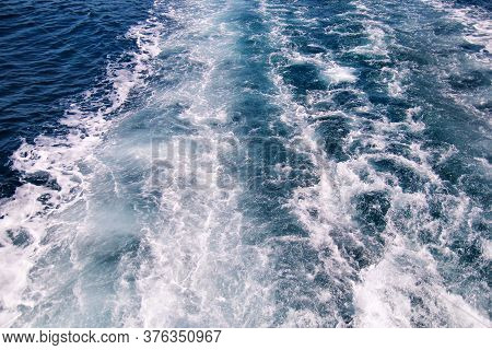 Turbulence Made By Foam Of Sea Water From A High-speed Yacht On Surface Of Sea. Blue Sea Waves With 