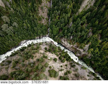 Aerial View Of Waterfalls And River Surrounded By Hills And Forest Trees. Highway 99 Near Pemberton 