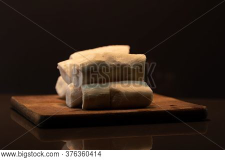 Edible Manioc Root (manihot Esculenta), Peeled And Frozen On Neutral Background