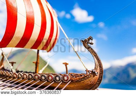 Old Wooden Viking Longboat Sails, Drakkar Boat On Fjord Shore In Norway. Tourism And Traveling Conce