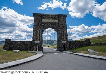 Gardiner, Montana - July 1, 2020: The Famous Roosevelt Arch At The North Entrance Of Yellowstone Nat