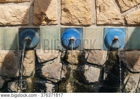Fountain With Blue Water Pipes And Clear Fresh Water At Polop De Marina, Costa Blanca, Spain