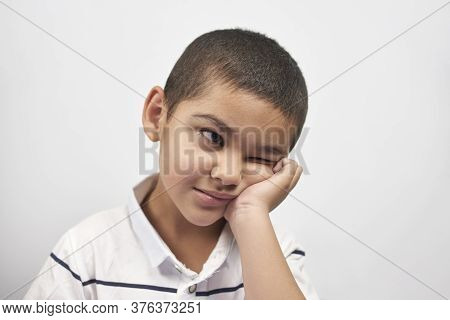 Bored Schoolboy Looking Tired Of Doing Homeworks. Kid Trying To Concentrate. Doing Online Classwork 