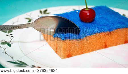 A Dish Sponge Is Placed On A Plate In The Form Of A Cake With A Real Cherry On Top. The Concept Of H