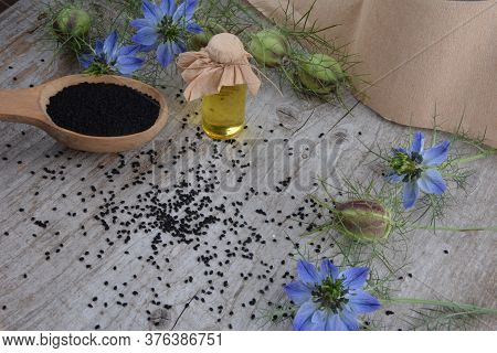 Black Cumin (nigella Sativa Or Kalonji) Seeds In Heart-shaped Bowl On Wooden Background